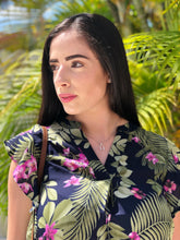Load image into Gallery viewer, Navy blue, v-neck blouse, with ruffled sleeves, green palm fronds and purple flower pattern.